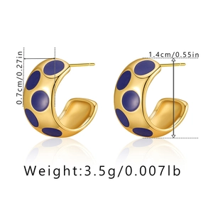 Detail view of gold C-shape earrings with blue polka dot enamel and precise size dimensions