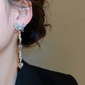 Elegant silver butterfly earrings with blue cubic zirconia tassels and dangling heart charms