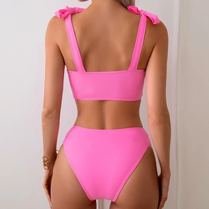 Back view of high-waisted pink bikini with elegant bow details on shoulder straps