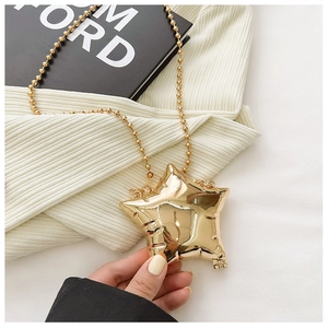 Detail of star-shaped gold mini bag with metallic finish and beaded chain strap