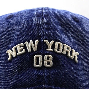 Detail of New York 08 3D embroidery on dark blue washed denim baseball cap texture
