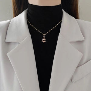 Elegant rose gold dancing stone angel wing pendant necklace worn by a fashion model