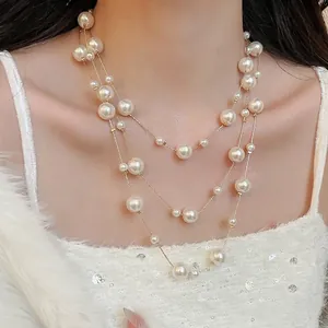 Elegant multi-layer pearl necklace with gold chain, layered style for classic women jewelry