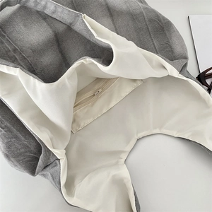 Detail view of tie-dye denim tote bag interior showing the white lining and zipper pocket
