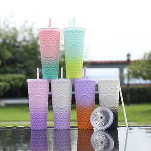 Pyramid stack of matte studded tumblers with textured geometric design and colorful gradients