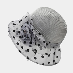 Detail of elegant organza flower with black polka dots on a silver sun hat