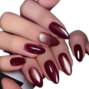 Glossy burgundy red cat eye press-on nails in elegant oval shape with shimmer effect