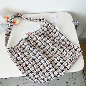 Detail of floral canvas tote bag showing the MISS woven label and vintage flower pattern