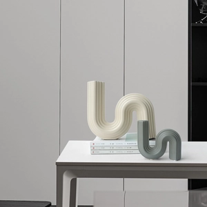 Modern minimalist S-shaped ceramic vases in cream and blue with a matte ribbed texture