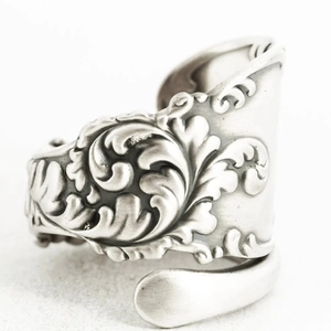 Vintage silver spoon ring featuring baroque floral relief and adjustable open band style
