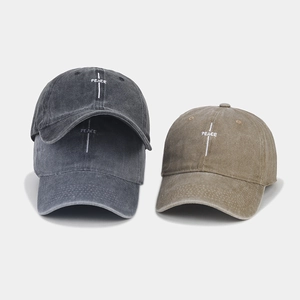 Detailed view of PEACE letter embroidery on a vintage washed cotton baseball cap