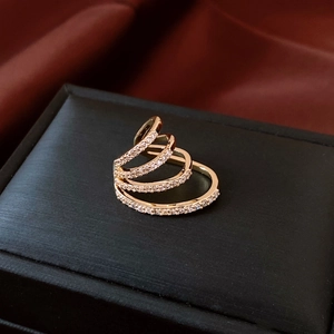 Macro shot of gold layered spiral ear cuff with micro-pave cubic zirconia on silk