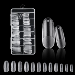 Detailed view of clear press-on nail tips in sizes 0-9 inside a plastic storage box