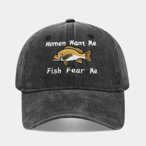 Close-up of the vintage washed cotton texture and detailed fish embroidery on baseball cap