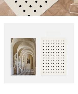 Detail of French minimalist cream door mat with black grid pattern on wooden floor