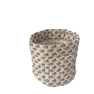 Quilted floral fabric cosmetic storage bin with red flower pattern on beige cotton