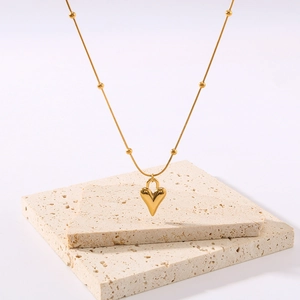 18K gold plated heart pendant necklace with beaded satellite chain on beige stone