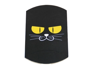 Detail view of black pillow gift box with yellow cat eyes for Halloween candy packaging