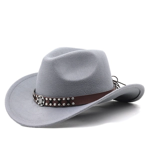 Close-up of grey felt cowboy hat featuring brown leather band with silver metal studs