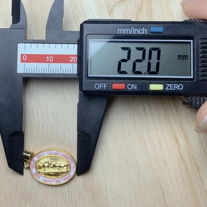 Detailed view of pink shell Jesus oval pendant measuring 22.0mm with digital caliper
