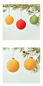 Detail of 6cm macaron flocked Christmas balls with golden caps hanging on pine branches