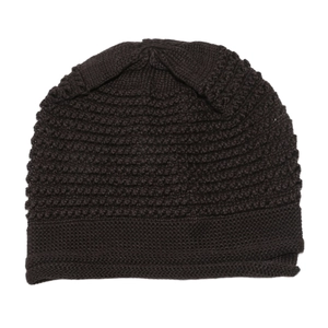Close-up of dark brown cable knit beanie showing thick texture and folded cuff detail