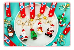 Detailed macro of 3D Christmas soft PVC keychains with Santa and Reindeer figures