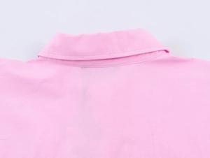 Macro view showing the collar stitching and poplin fabric texture of the pink shirt