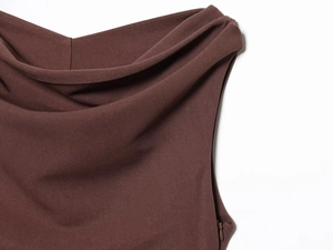 Detail eines eleganten kaffeebraunen Kleides mit Wasserfallkragen und Reißverschluss
