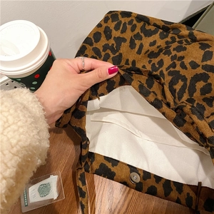 Detail of leopard print corduroy tote bag showing metal magnetic snap and canvas lining