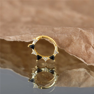 Detail of golden S925 sterling silver hoop with black triangle zircons and micro diamonds
