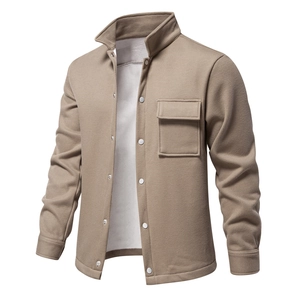 Close-up of khaki waffle knit fabric texture on men's jacket with metal snap button and pocket