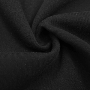 Macro detail of heavyweight black fleece-lined fabric with soft knitted texture