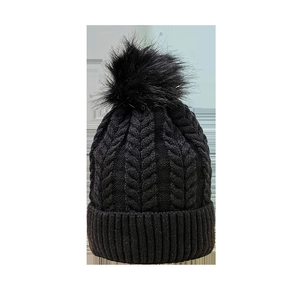 Stylish black cable knit beanie for women and men with a fluffy faux fur pom pom