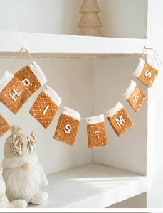 Detail of Christmas felt stocking banner with sequins and plush trim on rustic twine
