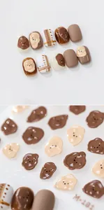 Detail macro view of 3D embossed bear nail stickers with brown plaid pattern design