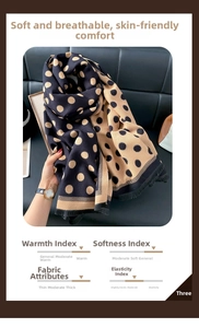 Close-up of thick winter scarf with vintage polka dot pattern and tassel fringe detail