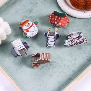 Christmas hair claws set with snowman glove and gingerbread man on green tray