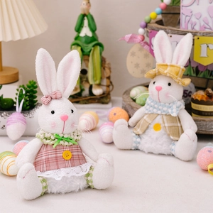 Detail of light-up Easter plush bunnies in plaid outfits with colorful decorative eggs