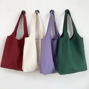 Solid canvas tote bags in four colors hanging on a wall for custom printing use