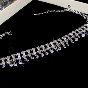 Macro shot of sparkling silver choker necklace with layered rhinestone fringe tassels