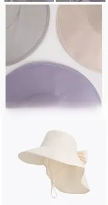 Detail of wide brim sun hats with bow decoration and adjustable windproof straps