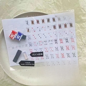 Miniature playing card DIY kit components including paper box models and a hair clip