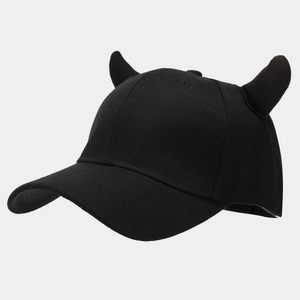 Dettaglio ravvicinato di un cappello da baseball nero con corna da diavolo decorative