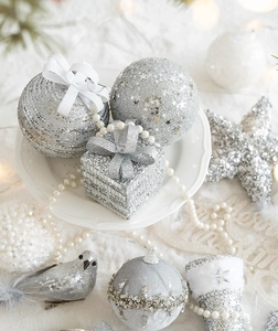 Silver Christmas ornaments featuring glitter balls, gift box charms and pearl chains