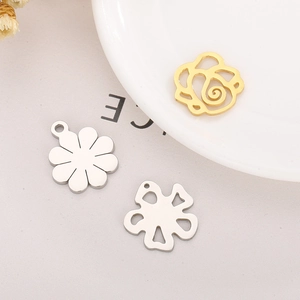 Detail view of stainless steel hollow rose and floral charm pendants for DIY jewelry