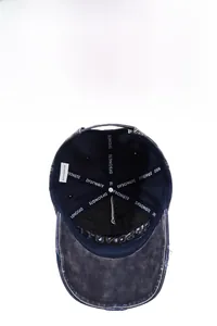 Detailed view of the washed navy baseball cap interior with reinforced logo tape