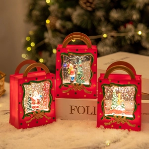 Three red Christmas lantern snow globes with festive Santa and winter tree scenes