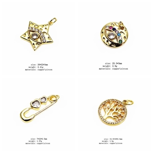 Detailed views of gold copper charms with zircon inlay showing star, eye, and tree designs