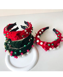 Close-up of velvet Christmas headband with decorative pearls and colorful rhinestones